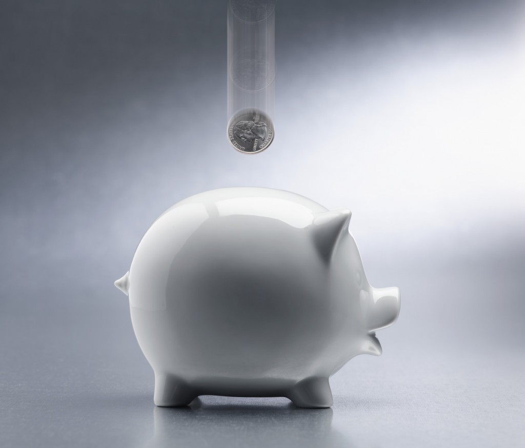 Coin Dropping Into Piggy Bank